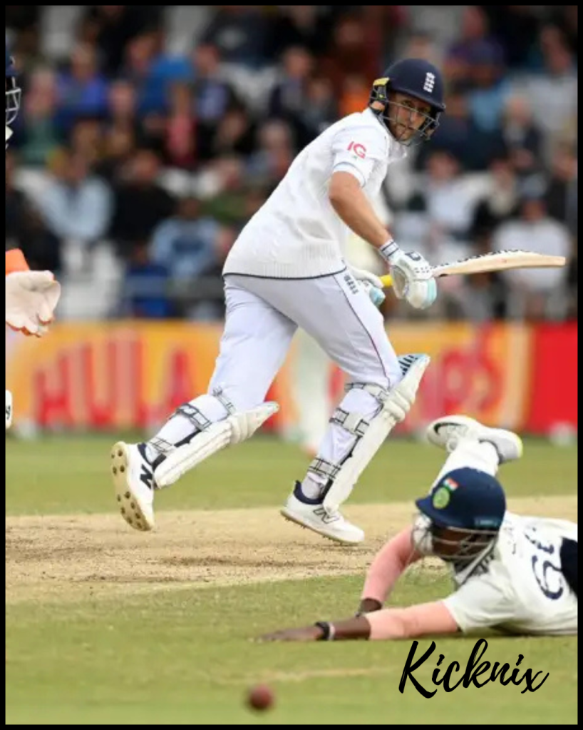 England's Joe Root playing an elegant shot to the boundary as an Indian fielder dives in a valiant attempt to stop the ball during an intense Test match.