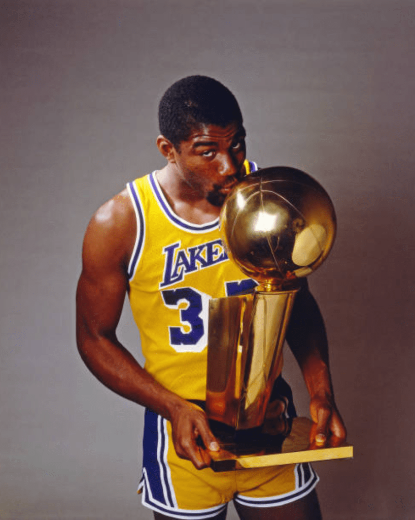 Magic Johnson on Lakers jersey with kissing trophy